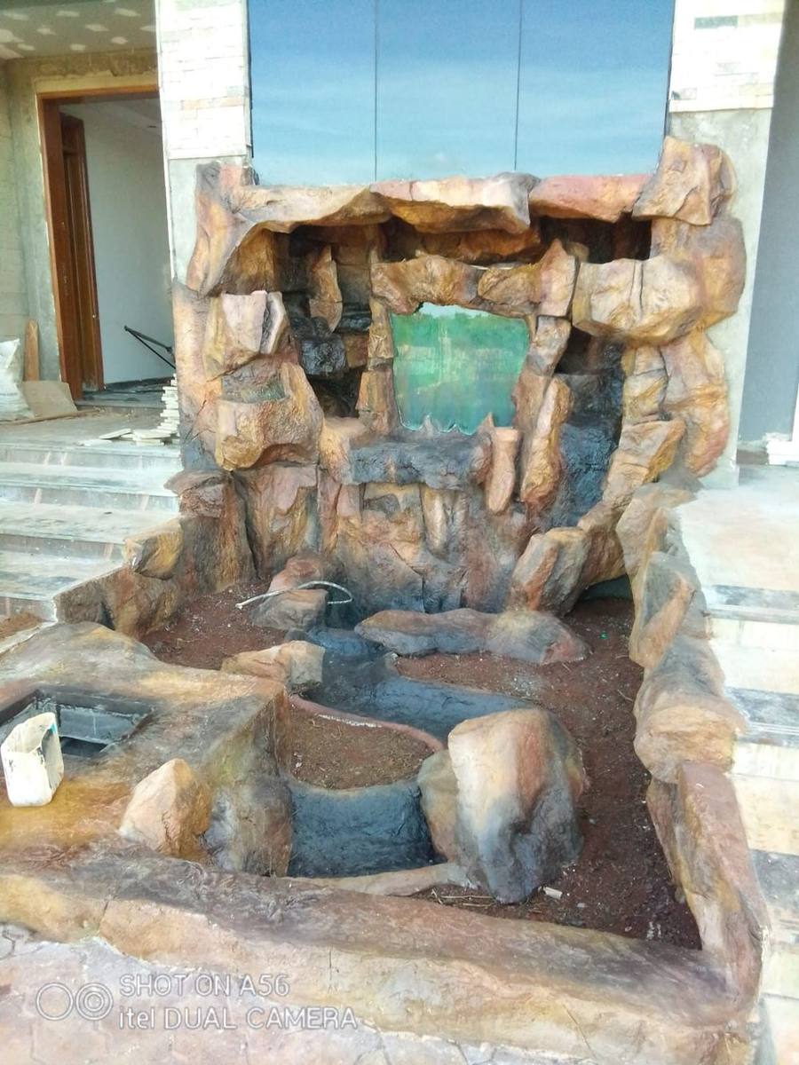 Rock water feature and fountain in a landscaped garden