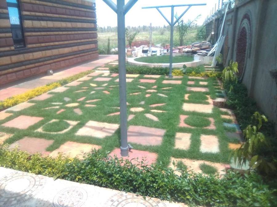 Aerial view of flower-pattern paved lawn with palm trees