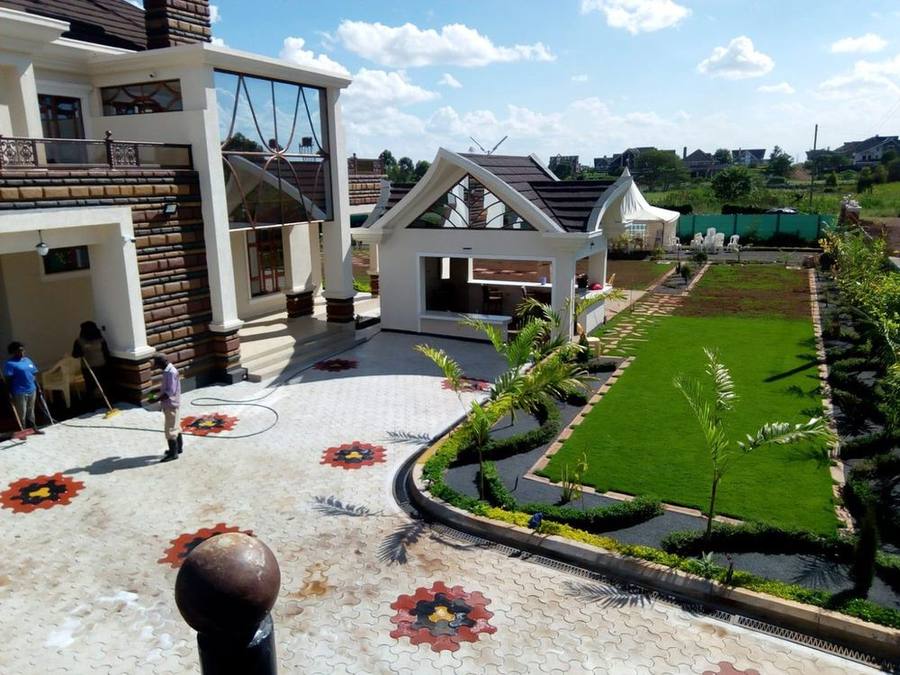 Landscaped compound entrance with turf and paving