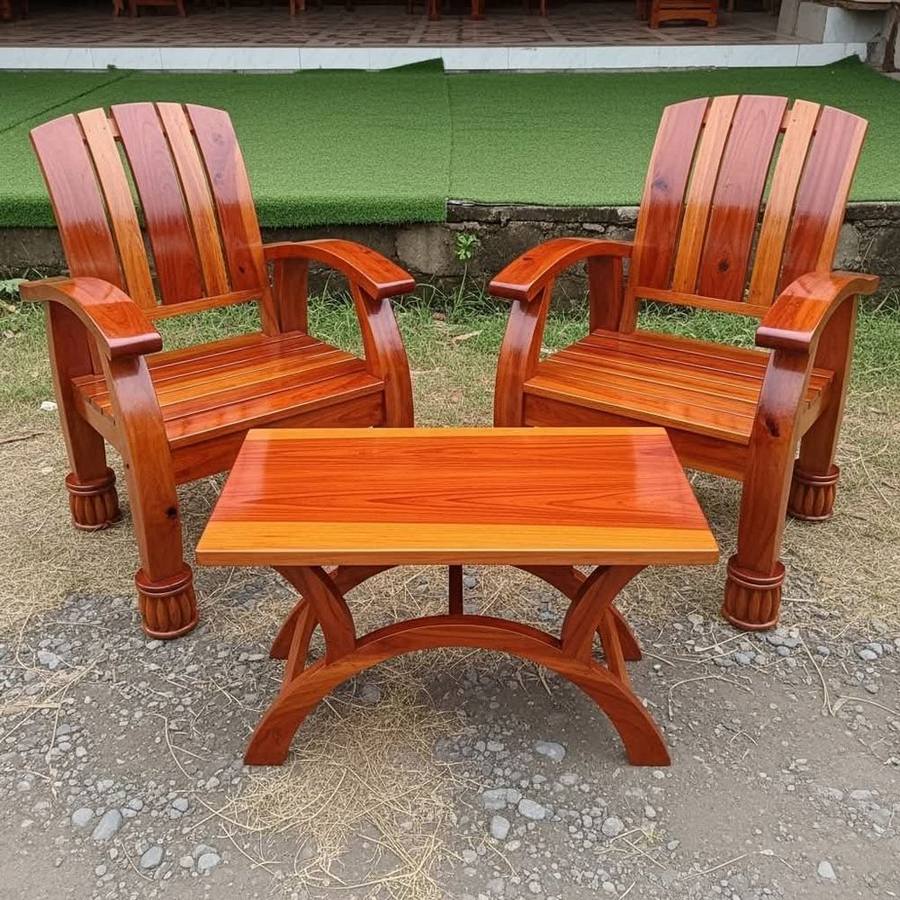 Pair of red-wood outdoor armchairs with a matching coffee table