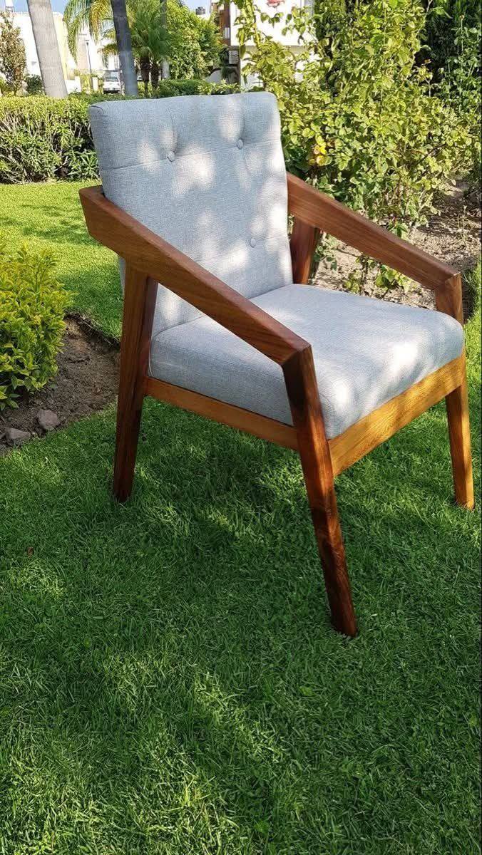Grey tufted armchair set outdoors on a lawn