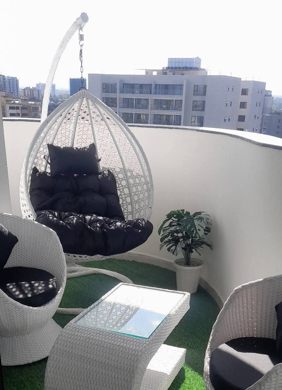Rooftop lounge seating with a hanging egg chair
