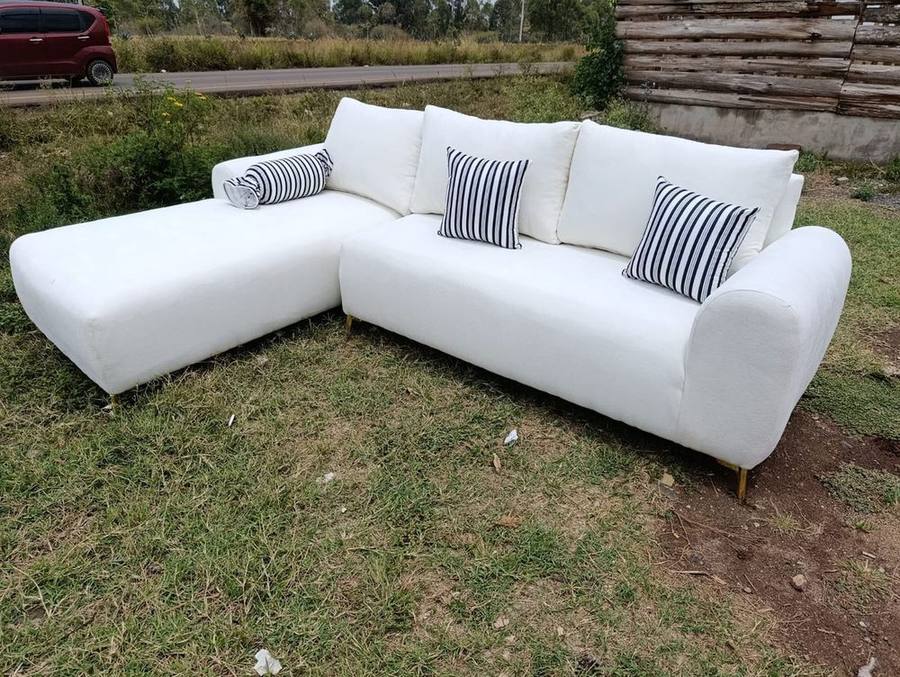 White modern sectional sofa with striped cushions