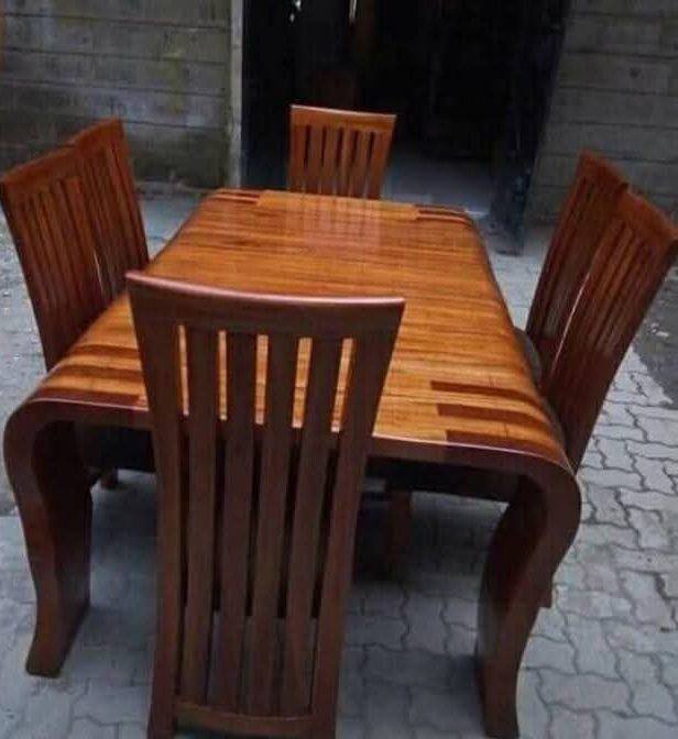Wooden dining table with four matching chairs