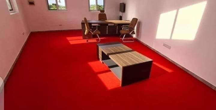 Red wall-to-wall carpet fitted in an office