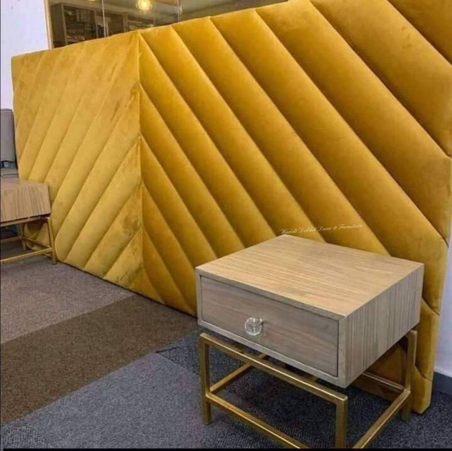 Mustard yellow channel-tufted headboard with bedside table
