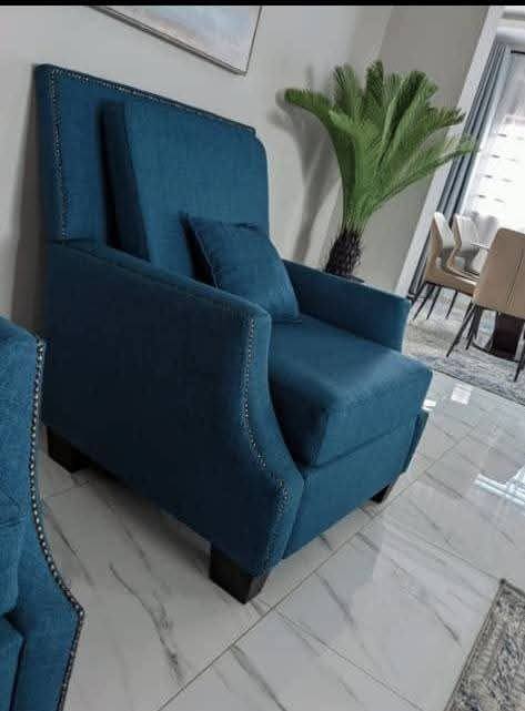 Blue upholstered wingback armchair